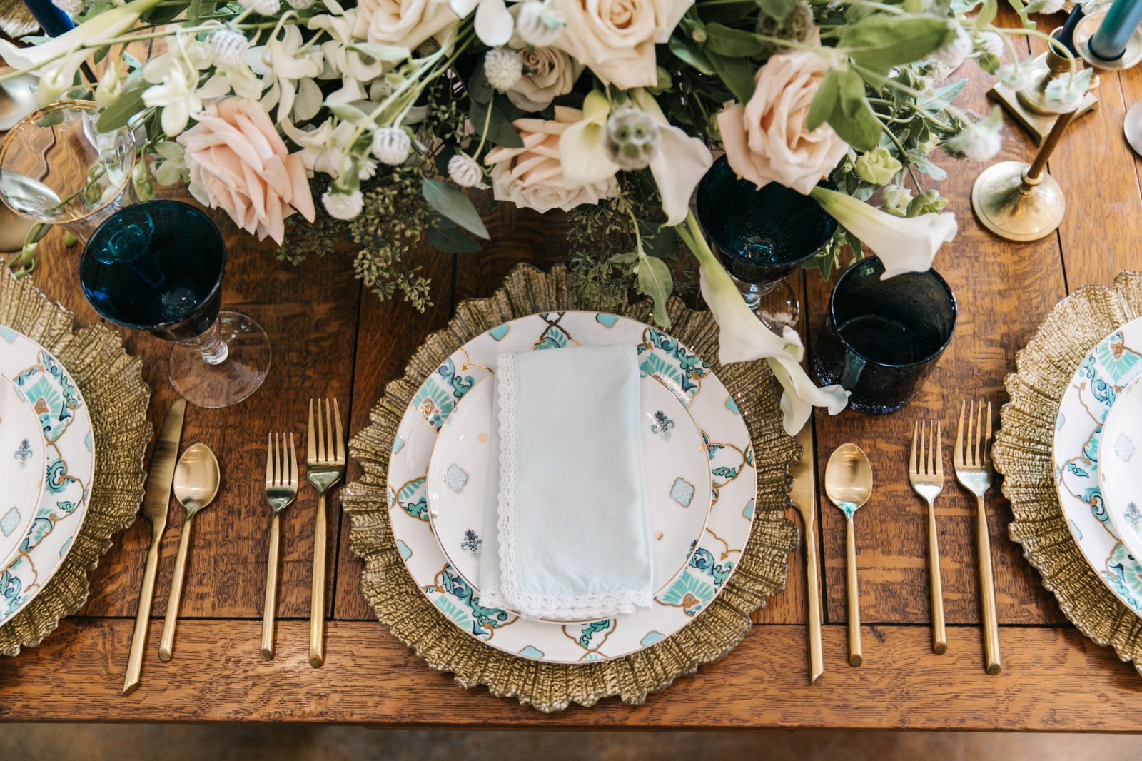 Styled wedding table with golden and blue accents from Marquee Event Rentals and flower centerpiece by Haute Floral photographed by Julia Sharapova