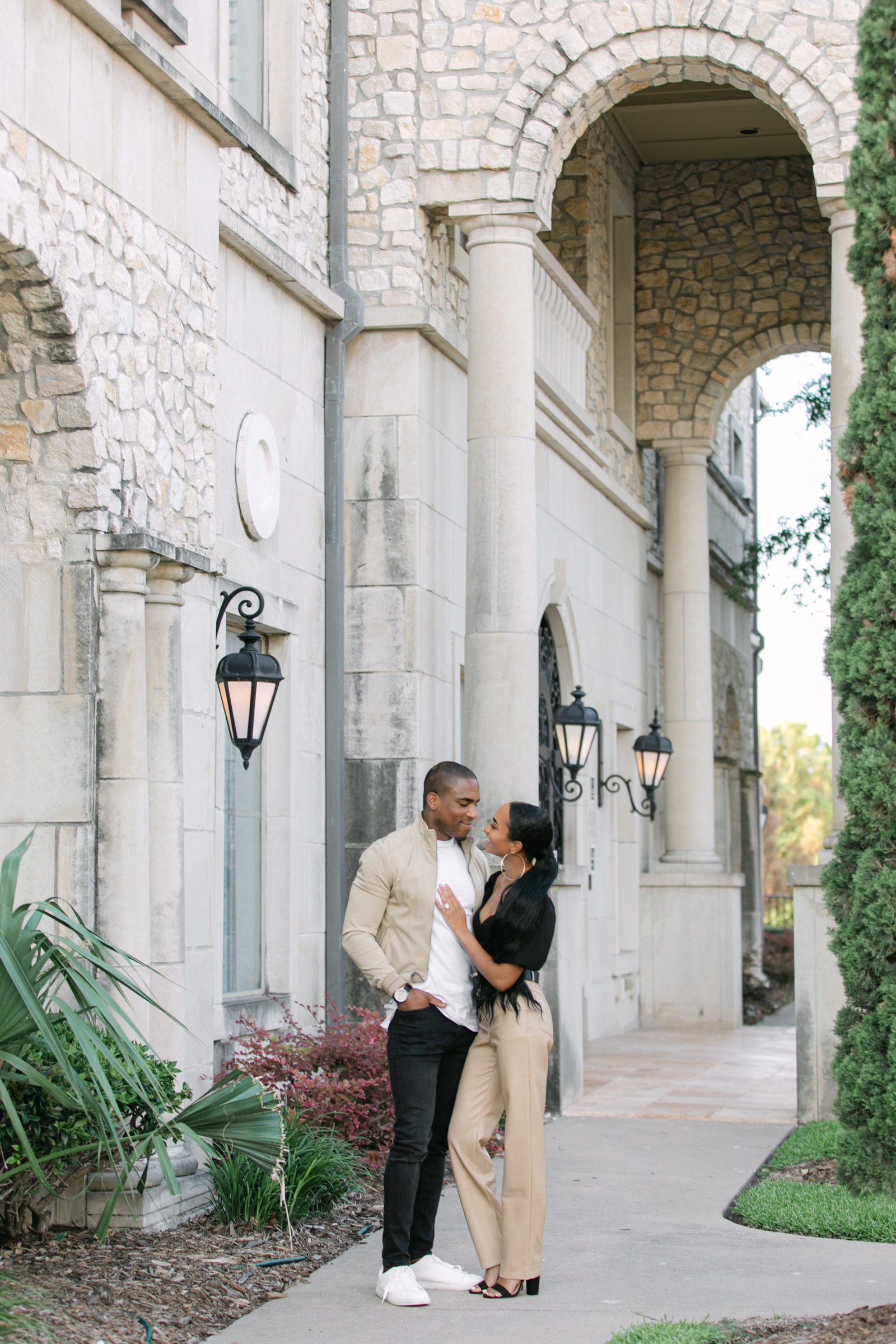 Candid portrait of couple laughing together at Adriatica Village, Dallas engagement session, showing genuine joy and love.