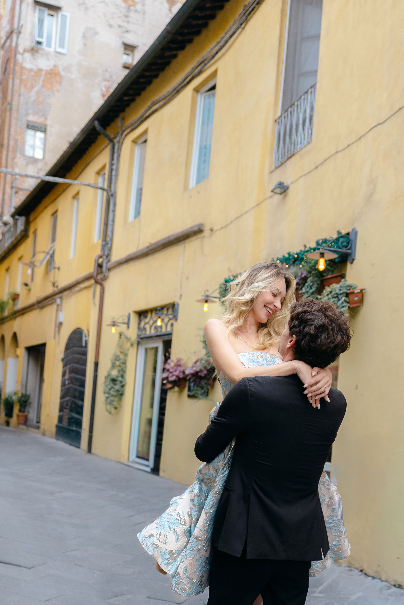 Happy engaged couple on the streets of Lucca